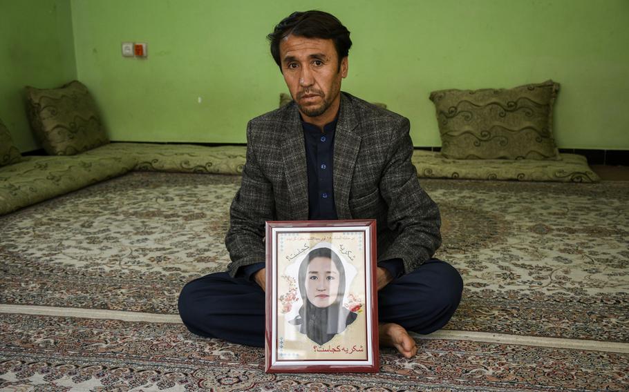 Abdullah Ahmadi holds a picture of his daughter Shukria, 18, on May 31, 2021. Shukria has been missing since a bombing killed at least 85 students at a girls’ school in western Kabul, Afghanistan on May 8, 2021.