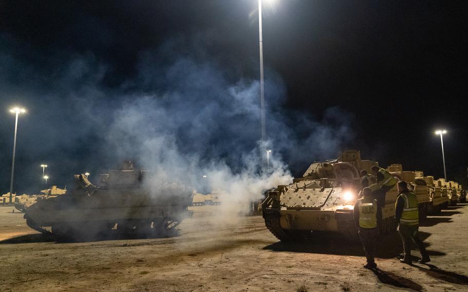 Stevedore drivers work through the night to load Bradley Fighting Vehicles onto the ARC Integrity on Jan. 25, 2023, at the Transportation Core Dock in Charleston, S.C. More than 60 Bradleys were shipped by U.S. Transportation Command as part of the U.S. military aid package to Ukraine. 