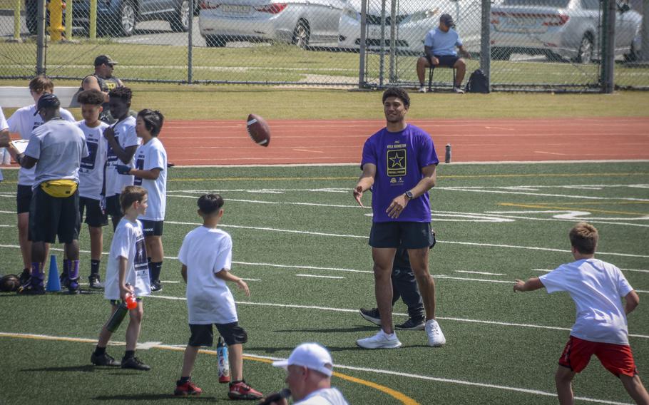 Baltimore Ravens strong safety Kyle Hamilton provides pro tips to young players at Camp Humphreys, South Korea, April 13, 2024.