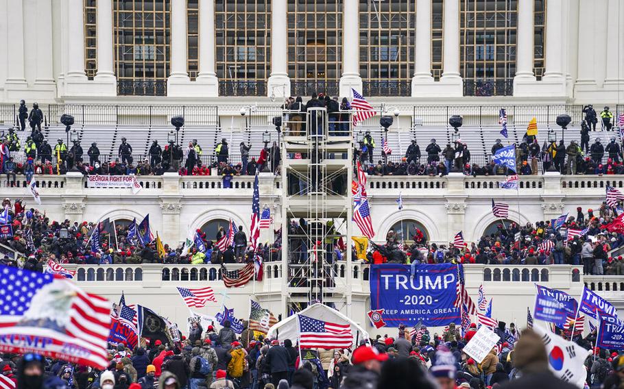 Rioters breach the Capitol in Washington on Jan. 6, 2021. Hatchet Speed, a U.S. Naval reservist who was assigned to an agency that operates spy satellites told an undercover FBI agent that he stormed the U.S. Capitol with members of the Proud Boys, according to court records unsealed on Thursday, June 23, 2022.