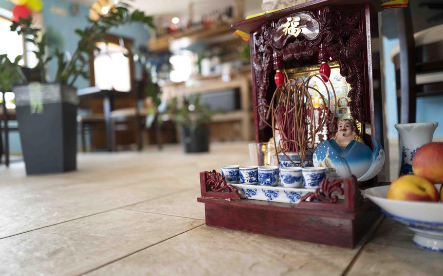 A small shrine adorned with offerings of fruit and incense aims to bring good luck for the owners at Bun Viet, a Vietnamese restaurant in Unterammergau, Germany.