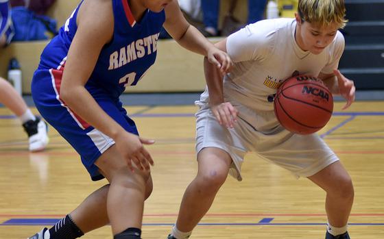 Wiesbaden's McKinley Vines, right, and Ramstein's Alysha Edwards fight for the ball on the baseline during the first quarter of Tuesday's game at Wiesbaden High School in Wiesbaden, Germany.