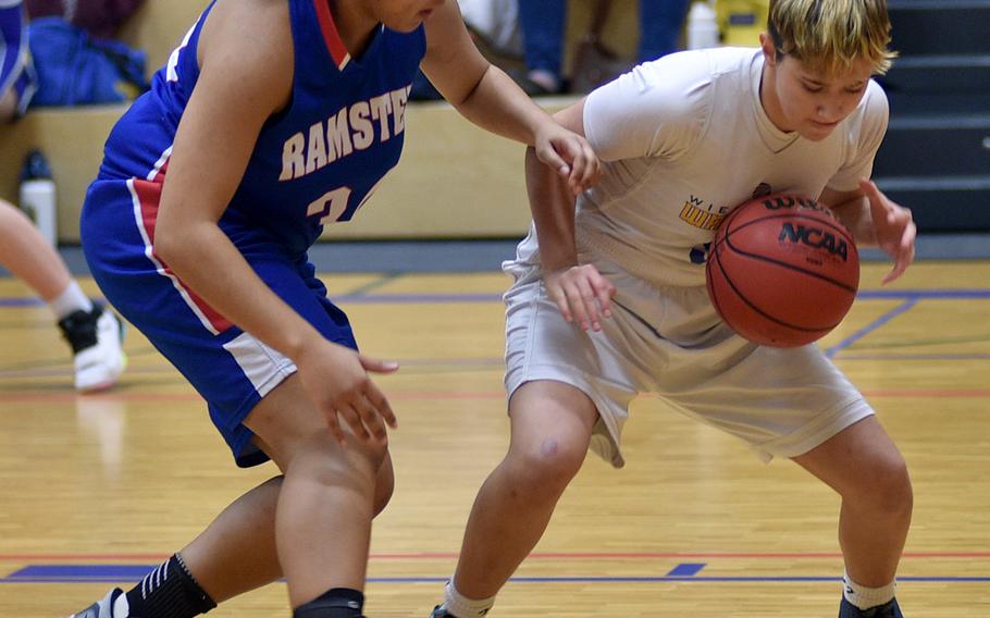 Wiesbaden’s McKinley Viers, right, and Ramstein’s Alysha Edwards fight for the ball on the baseline during the first quarter of Tuesday’s game at Wiesbaden High School in Wiesbaden, Germany.