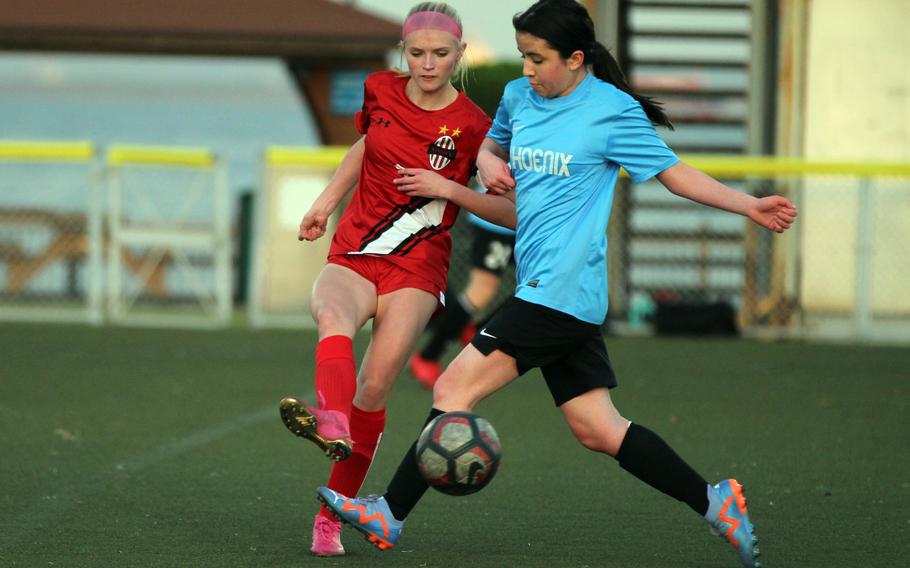 Nile C. Kinnick’s Hailey Witt and Seisen‘s Lily Kawahata tussle for the ball during Tuesday’s Kanto Plain soccer match. The Red Devils won 13-1.