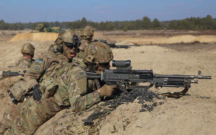 An assistant gunner shouts commands to a M240 gunner on March 17, 2022, while engaging targets during a live-fire exercise in Poland involving paratroopers assigned to the 1st Battalion, 505th Parachute Infantry Regiment, 3rd Brigade Combat Team, 82nd Airborne Division and Polish soldiers with the 19th Mechanized Brigade. 