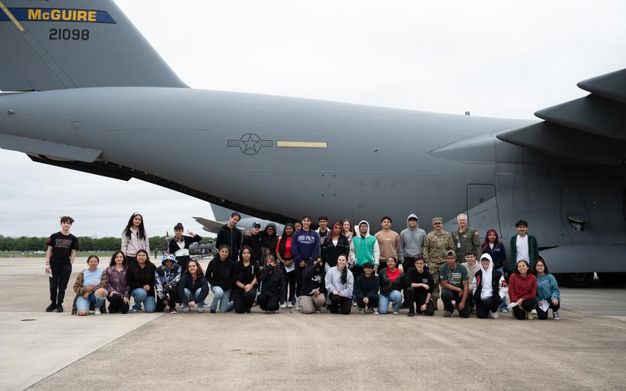 Students pose for a photo in front of a C-17 Globemaster III during the Student Engagement and Career Day event at Joint Base McGuire-Dix-Lakehurst, N.J., Friday, April 19, 2024. 