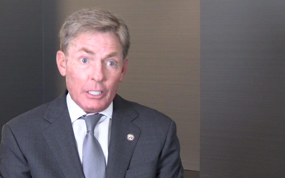 A video frame of Ken Fisher in a suit and gray tie speaking.