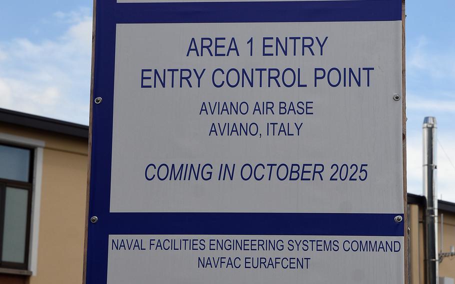 A sign is posted at the gate of a military installation.