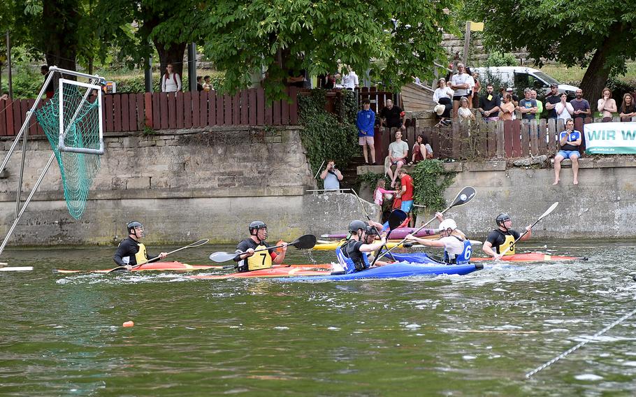 Players enjoy a game of kayak polo.
