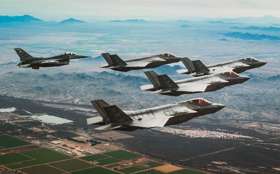 Air Force F-35A Lightning II jets and an F-16 Fighting Falcon fly in formation Jan. 19, 2024, over Luke Air Force Base, Ariz. Global military spending reached a record high of $2.4 billion last year, up 7% from 2022, the Stockholm International Peace Research Institute said in a report released April 22, 2024.