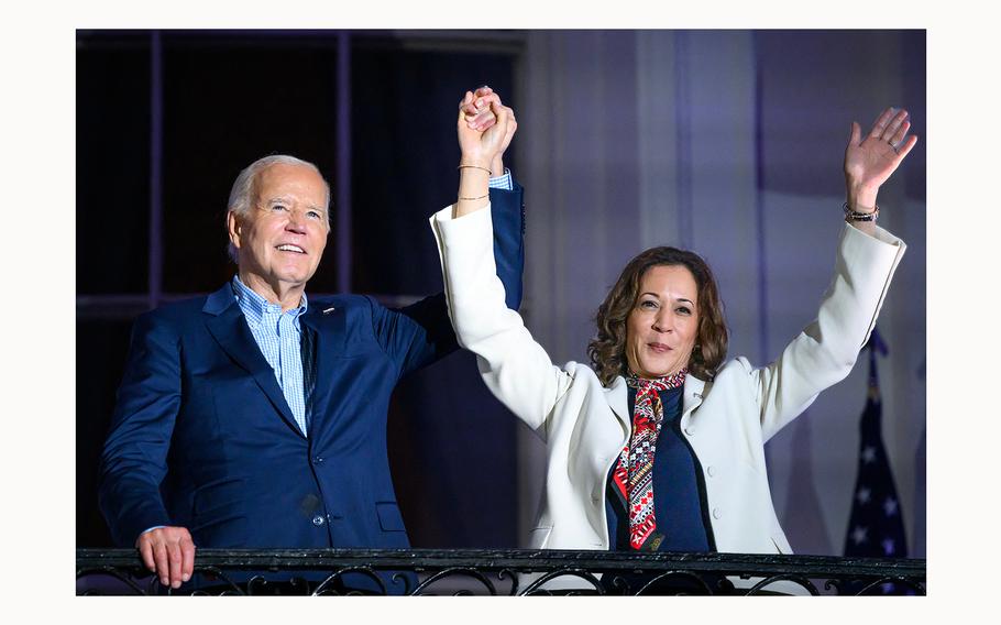President Joe Biden and Vice President Kamala Harris raise their arms as guests cheer after watching the Independence Day fireworks from the White House in Washington, D.C., on July 4, 2024. 