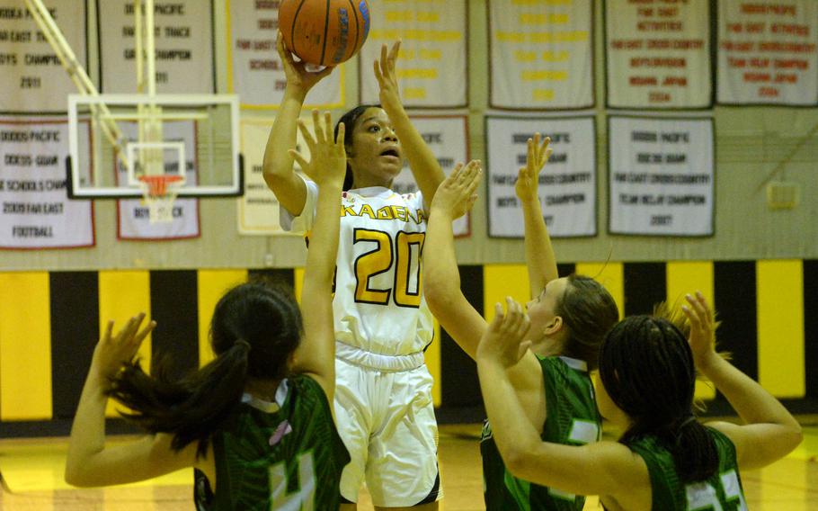 Kadena's Ayanna Levi skies for a shot over Kubasaki's Jacquilline Mitchell, Bianca Loor and Alannah Ridgway during Thursday's Okinawa basketball game. The Panthers won 55-15.