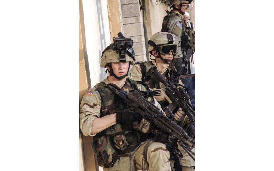 Mosul, Iraq, October 2004: Soldiers with 1st Battalion, 24th Infantry Regiment stand vigilant during an early-morning search of a neighborhood in Mosul.