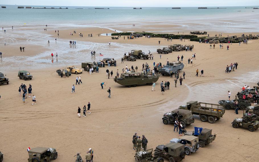 People gather on the beach at Arromanches-les-Bains, France, to commemorate the 80th anniversary of the D-Day landing, Tuesday, June 4, 2024.