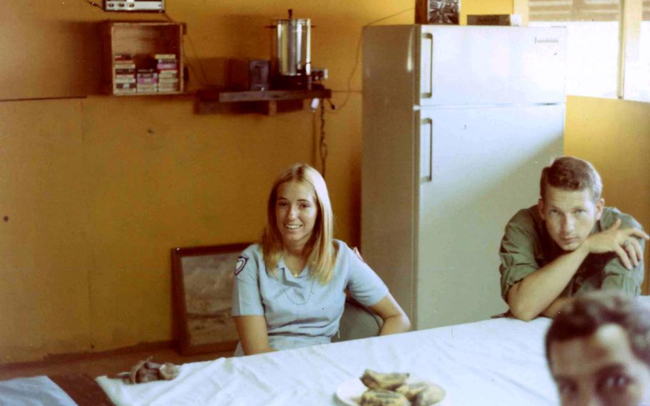 A "Donut Dolly" now identified as Karen Jankowski is shown visiting U.S. Army troops at the regional forces camp in the village of Dong Xoai, Vietnam, in 1971. For decades, Army veteran Jim Roberts searched for the two women who visited his team that day so he could thank them. Sitting on the right (full face) is Capt. Jim Rice, leader of the Mobile Advisory Team. Partially seen is the unidentified escort officer who was accompanying the Dollies on the tour.