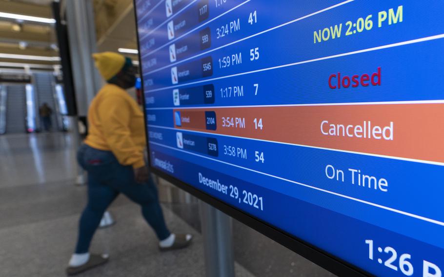 A flight shows cancelled on the departures board at Ronald Reagan Washington National Airport, Wednesday, Dec. 29, 2021, in Arlington, Va. 