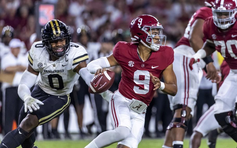 Alabama quarterback Bryce Young (9) works away from pressure from Vanderbilt linebacker Anfernee Orji (0) on Sept. 24 in T. The Crimson Tide  during the second half of an NCAA college football game Saturday, Sept. 24, 2022, in Tuscaloosa, Ala. (AP Photo/Vasha Hunt)