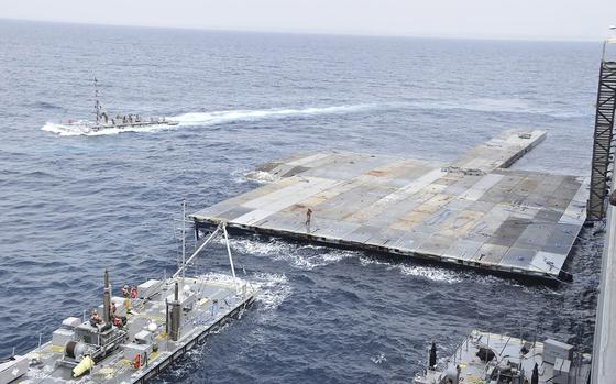 U.S. military personnel construct a floating pier in the Mediterranean Sea off the Gaza Strip in April 2024.