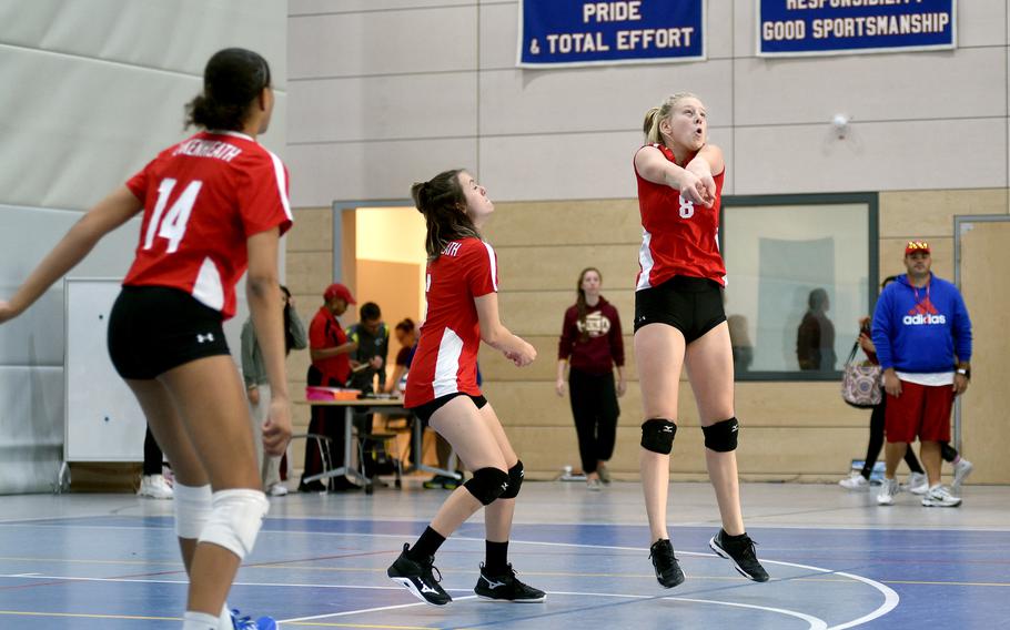 Lakenheath's Chloe Aldrich, right, hits the ball as A'lydia McNeal, left, and Arianna Christian watch during a match against Vilseck on Thursday during the DODEA European volleyball championships at Ramstein High School at Ramstein Air Base, Germany.

Matt Wagner/Stars and Stripes