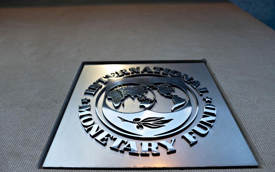 Signage hangs at the International Monetary Fund (IMF) headquarters in Washington, D.C., on April 14, 2020. 