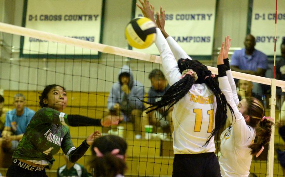 Kubasaki's Risha McGriff spikes against Kadena's Liza Young and Deniz Dussetschleger during Tuesday's DODEA-Okinawa volleyball match. The Dragons won in four sets.