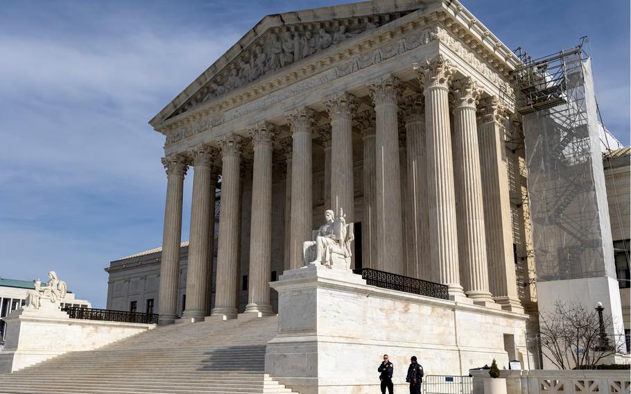 An exterior view of the front of the U.S. Supreme Court building, with stone steps leading up to columns by the entrance.