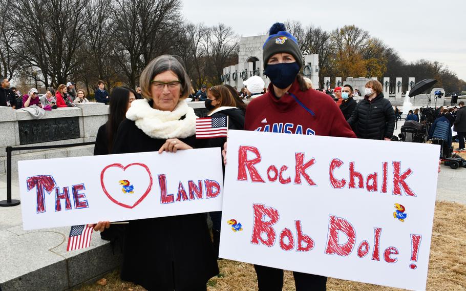 Anne Gramesch, left, and Marilyn Jenkins, right, attend the public remembrance of Sen. Bob Dole at the National World War II Memorial on Friday, Dec. 10, 2021. Jenkins, an Air Force veteran, is from Kansas and attended the University of Kansas, as did Dole.  