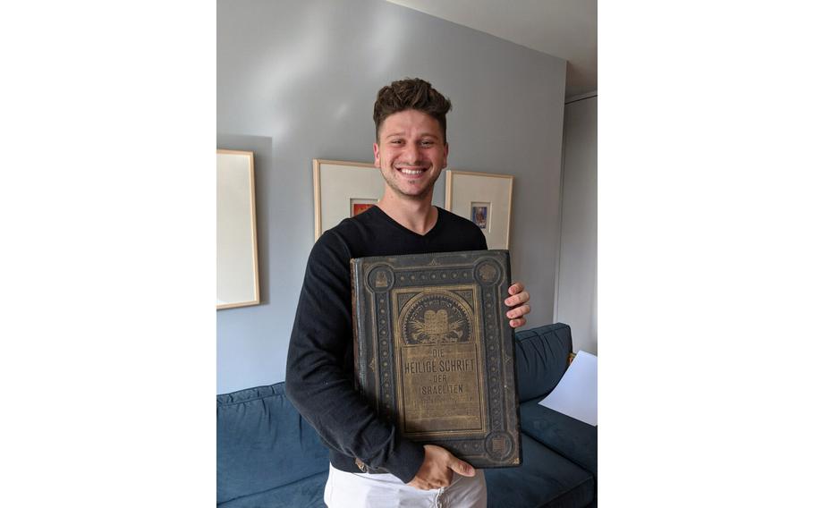 Jacob Leiter holds the Bible belonging to his great-great-grandparents.