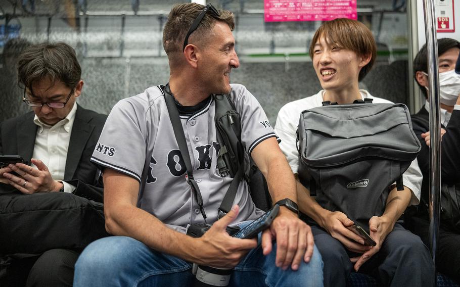 Justin Morrelli shares a smile with a local on a Tokyo train, May 23, 2025.