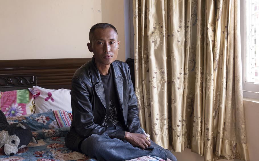 Anil Lama, a former I.T. worker for KGL at an American military installation in Kuwait, poses for a portrait at his residence in Kathmandu, Nepal on Oct. 8, 2022.