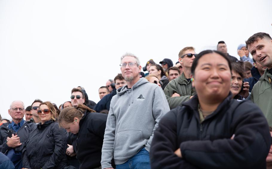 Guests observe an air power demonstration on the flight deck of the USS Abraham Lincoln