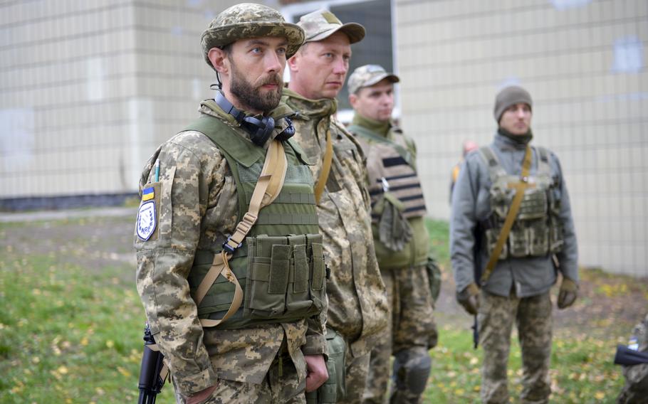 Ukrainian soldiers gather to practice combat first aid at a training site on the outskirts of Kyiv, on Oct. 27, 2022.