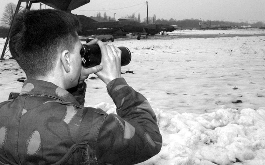 Taszar AB, Hungary, January, 1996: A Hungarian airman scopes out the sites while standing guard at Taszar AB.