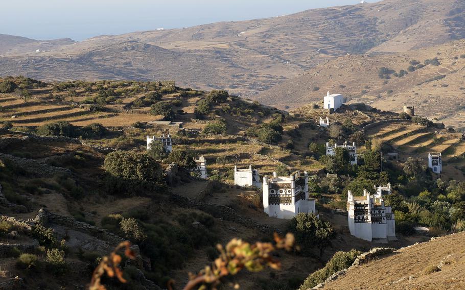 A profusion of dovecotes built like fantastically carved towers dots the countryside among stonewalled terraces in Tinos island, Greece, on August 27, 2021. The Cycladic island has many marble-decorated villages linked by remote mountain roads. 