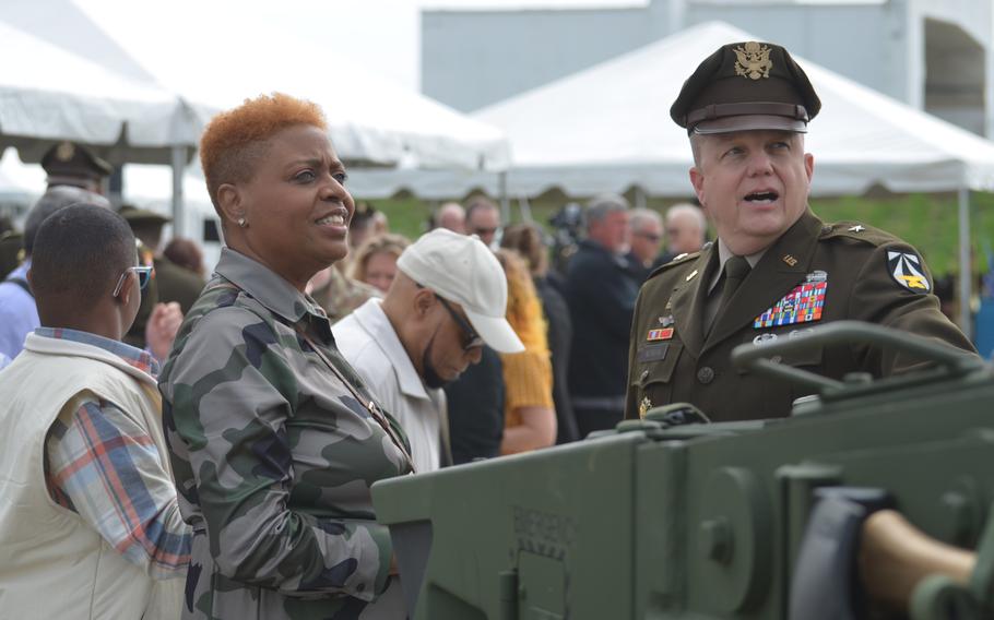 Kimberly Talley-Armstead, the sister of Staff Sgt. Stevon A. Booker, speaks with Brig. Gen. Geoffrey Norman in front of the Army’s new combat vehicle, M10 Booker, before a dedication ceremony Thursday, April 18, 2024, at Aberdeen Proving Ground, Md. 