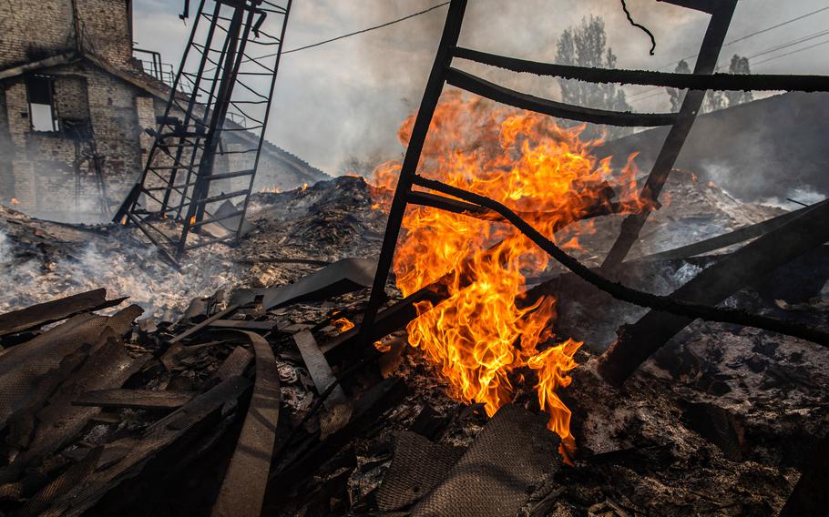 Burst out flames can be seen in the ruins of a grain silo in the town of Sivers’k, in Ukraine’s Donbas region. 