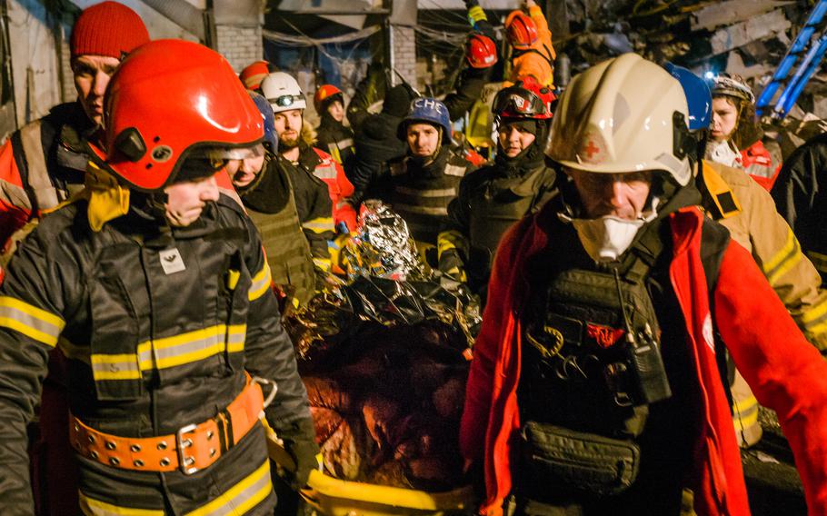 Rescue workers transport a victim from the rubble.