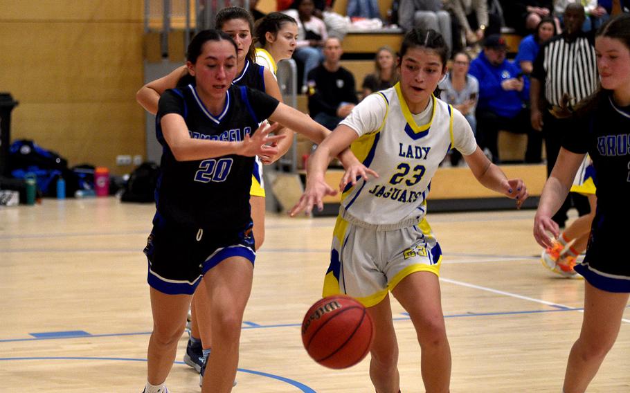 Brussels forward Haley Mitchell and Sigonella guard Ryleigh Denton fight after a loose ball during pool-play action of the DODEA European basketball championships on Feb. 14, 2024, at the Wiesbaden Sports and Fitness Center on Clay Kaserne in Wiesbaden, Germany.