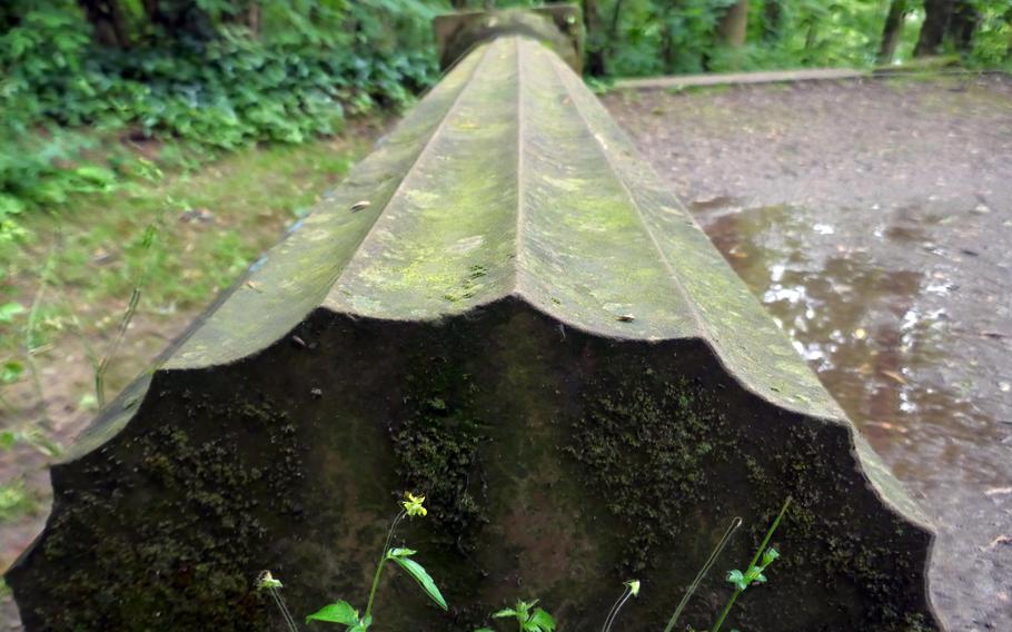 A sandstone column sculpted by the Scottish artist and lyricist Ian Hamilton Finlay gathers moss on the side of a path near the Goetheturm in Frankfurt. Many foot and bike paths crisscross the forest on Frankfurt’s south side.