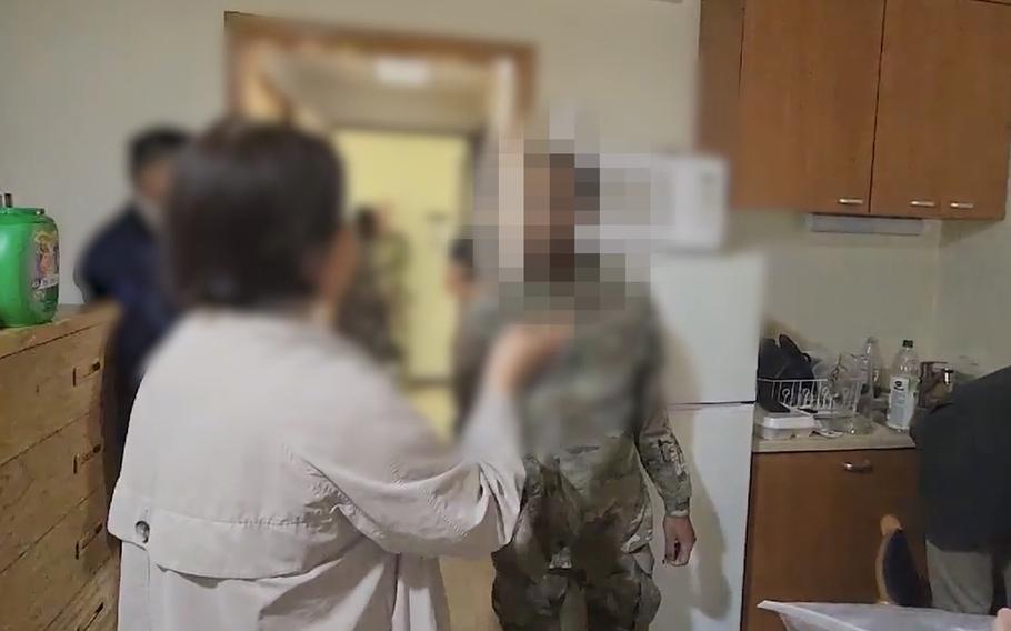 This undated image, censored by police, shows a U.S. soldier being questioned during a synthetic cannabis raid inside a barracks at Camp Casey, South Korea.