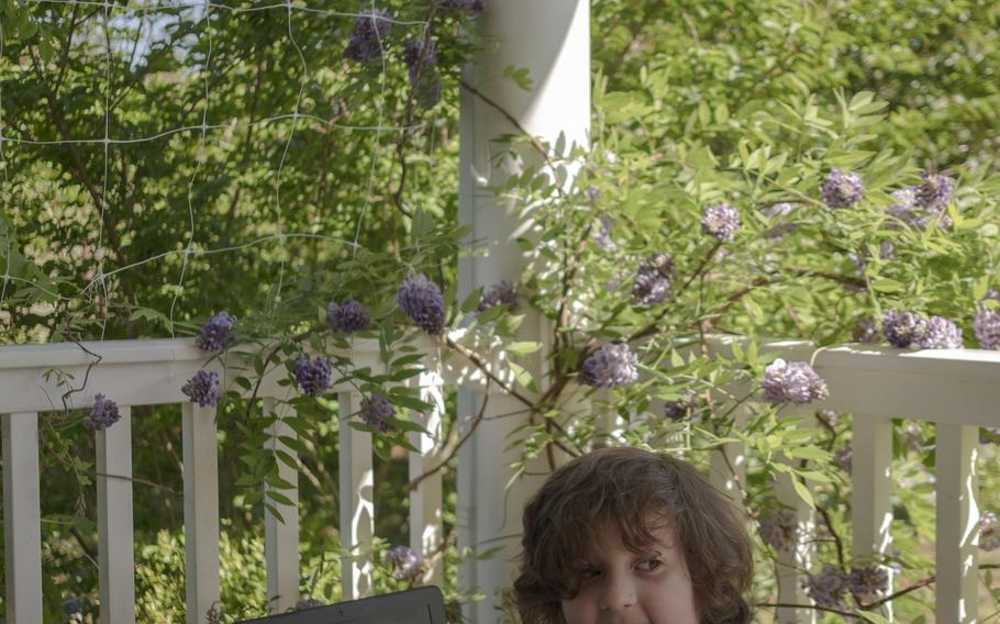 Robert, 6, attends virtual school on the deck of his home in Fredericksburg. 