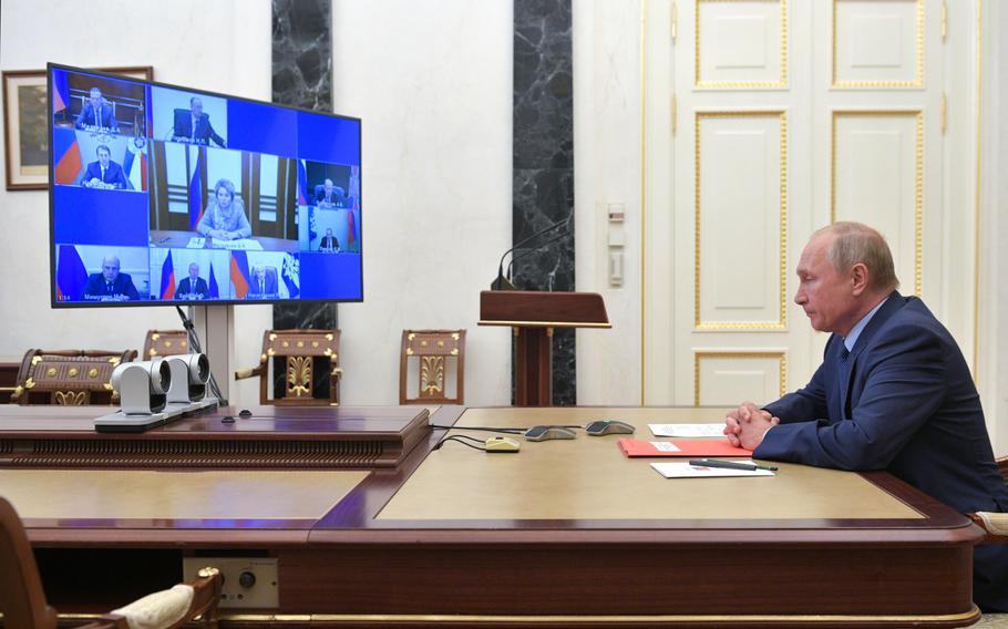 In this file photo, Russian President Vladimir Putin attends a meeting with the members of the Security Council via teleconference call, in Moscow, on Oct. 16, 2020.