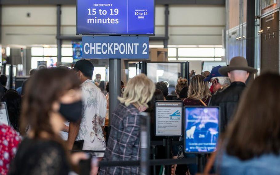 Travelers wait to go through security checkpoints at Austin-Bergstrom International Airport on May 28, 2021. 