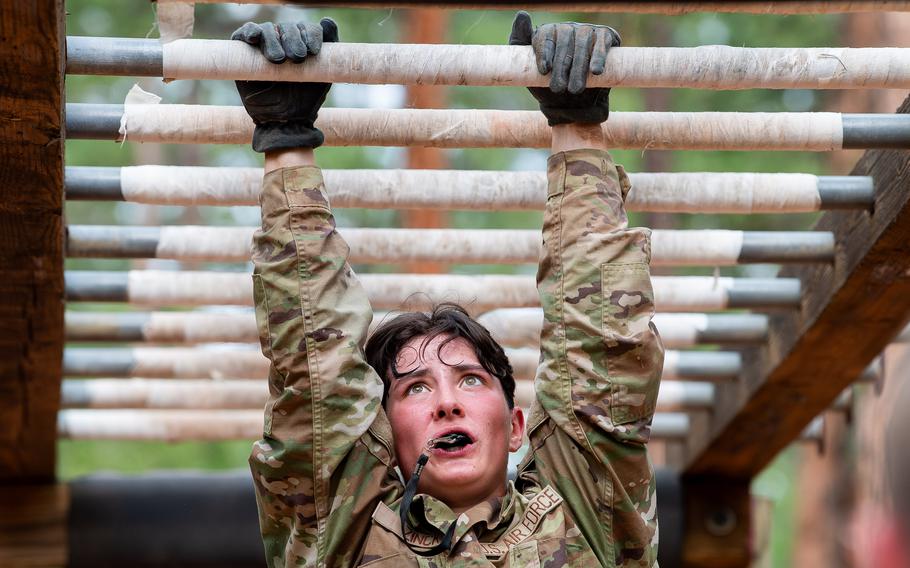 A cadet does the monkey bars