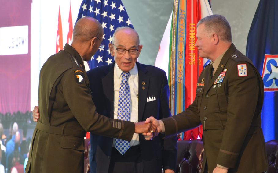 Gen. Charles Hamilton, commander for the Army Material Command, embraces Lt. Gen. Arthur Gregg and Maj. Gen. Mark Simerly, commander for the Combined Arms Support Command, after speaking to the audience at a renaming ceremony for Fort Lee, Va. The Army post was renamed Fort Gregg-Adams on Thursday, April 27, 2023, in honor of Gregg and Lt. Col. Charity Adams, two Black officers who helped pave the way for an integrated military. 