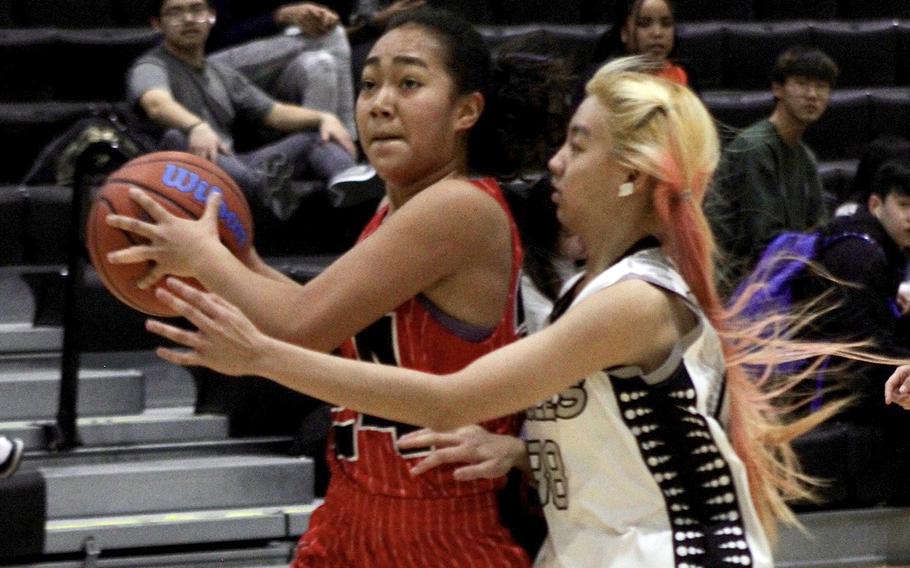 Nile C. Kinnick's Kotone Turner drives to the basket against American School Bangkok during Monday's Far East Girls Division I round-robin game, won by the Red Devils 55-21.