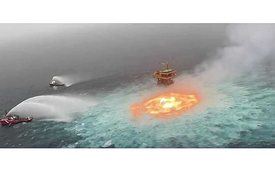 A video screen grab shows fire boats working to put out a fire that raged on the surface of the Gulf of Mexico on Friday, July 2, 2021.