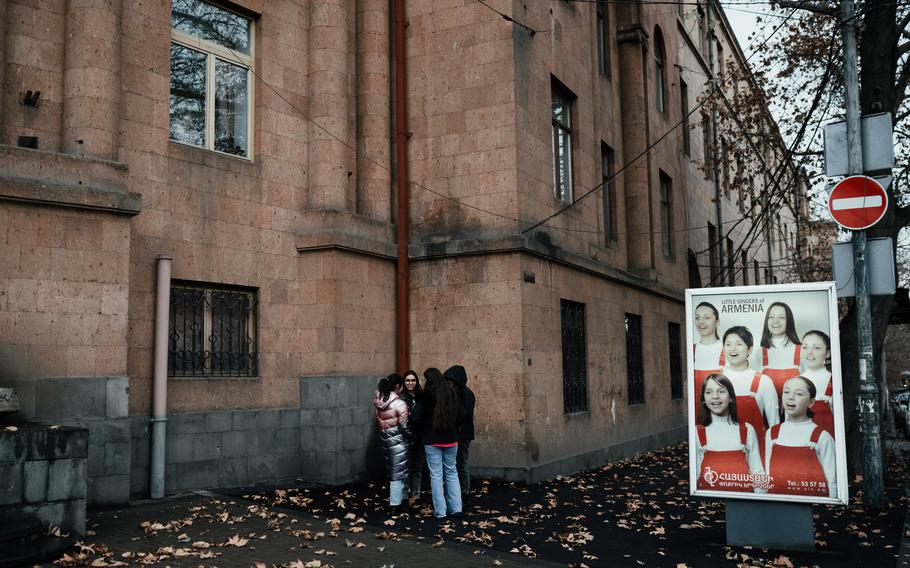 Young girls talk in front of Sayat-Nova Music School in Yerevan, Armenia, on Feb. 2.