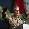 Gen. Alexus Grynkewich gestures behind a podium as he speaks in uniform.