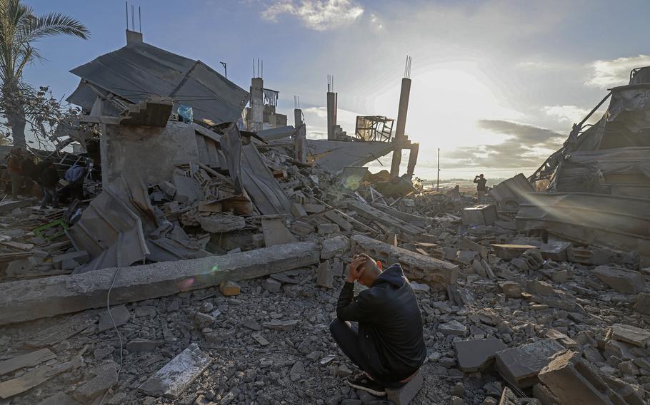 A man sits amid the debris of destroyed houses in the aftermath of Israeli bombardment in Rafah in the southern Gaza Strip on Feb. 22, 2024. 